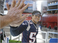 Tedy Bruschi leaves the field after Media Day at the University of Phoenix Stadium.