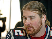 Offensive lineman Matt Light sits at his table and answers a question during a media availability.
