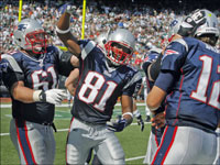 Left to right, the Patriots Stephen Neal, Randy Moss, Dan Koppen (partially hidden) and Tom Brady celebrate after Brady and Moss hooked up on a 51 yard touchdown pass.