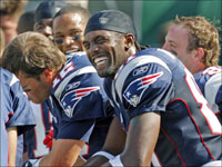 There were smiles all around on the Patriots bench after quarterback Tom Brady (left) and wide receiver Randy Moss (front) hooked up for a third quarter 51 yard touchdown pass against the Jets.