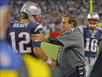 Patriots head coach Bill Belichick (right) gives QB Tom Brady a handshake as he comes off the field after being pulled late in New England's Week 2 victory.