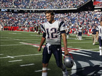 New England Patriots quarterback Tom Brady walks off the field smiling after the Patriots defeated the Buffalo Bills 38-7 at Gillette Stadium.