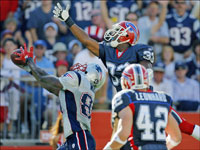 Patriots wide receiver Randy Moss (left) beat Bills' cornerback Jabari Greer (33) as he hauls in a 45 yard touchdown pass from Tom Brady, his second of the game, which put the exclamation point on New England's 38-7 victory over the Buffalo Bills at Gillette Stadium.