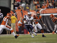 Patriots cornerback Ellis Hobbs returns a kick off 31 yards as he splits Cincinnati Bengals Herana-Daze Jones (44), Marvin White (26), and Madieu Williams in week 5.