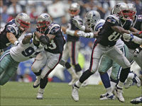 The New England Patriots running back Kevin Faulk runs behing the blocking of teammate Randy Moss during 3rd quarter action against the Dallas Cowboys at Texas Stadium.