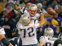 Patriots wide reciever Jabar Gaffney is hoisted by lineman Matt Light after he caught the game-winning touchdown pass.