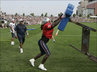 Running back Laurence Maroney participated in a blocking drill on the first day of Patriots training camp July 27.