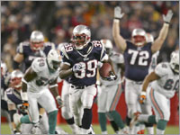 Patriots wide reciever Jabar Gaffney is hoisted by lineman Matt Light after he caught the game-winning touchdown pass.