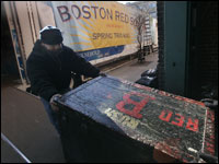 Red Sox equipment for spring training gets loaded up onto a van with a banner outside Fenway Park.  (Globe Staff Photo/ Suzanne Kreiter)