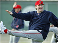  Curt Schilling gets a leg up as he works out on the field during the first day of official workouts at Spring Training.   (Globe Staff Photo/ Jim Davis)