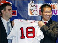  Daisuke Matsuzaka (right) has a big smile as he holds up his new Red Sox jersey at the press conference. At left is Red Sox GM Theo Epstein. (Globe Staff Photo/ Jim Davis)