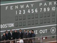 Daisuke Matsuzaka and Scott Boras lined up in front of the Green Monster at Fenway Park with Red Sox officials. (Globe Staff Photo/ David L. Ryan)
