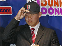 Daisuke Matsuzaka tries on a Boston Red Sox hat for the first time. (Globe Staff Photo/ David L Ryan)
