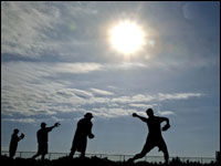 The early morning sun is rising in the sky as some of the Red Sox pitchers who are already in camp are seen throwing off some of the many pitcher's mounds in the bullpen area.   (Globe Staff Photo/ Jim Davis)