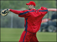 Red Sox captain Jason Varitek arrived in camp this afternoon after all the workouts were finished, so when he went out to play catch, the lawn on the field was being mowed.   (Globe Staff Photo/ Jim Davis)