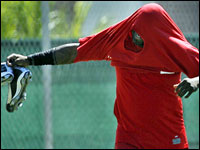 Who is that hooded man?.......Red Sox DH David Ortiz made his first appearance on a field today, here he is shown putting on his sweatshirt as he walked to one of the back fields to participate in the position players conditioning workout this afternoon..   (Globe Staff Photo/ Jim Davis)