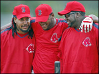 Red Sox leftfielder Manny Ramirez surprised everyone by showing up in camp early this morning. He is shown at left with teammates Wily Mo Pena (center) and David Ortiz (right) as they get together on the way to take batting practice.     (Globe Staff Photo/ Jim Davis)