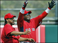 Red Sox sluggers Manny Ramirez and David Ortiz gesture to someone they know on the Blue Jays who is warming up on the other side of the field before this afternoon's game at City of Palms Park.   (Globe Staff Photo/ Jim Davis)