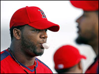 The presence of Manny Ramirez (right) in leftfield, (as well as J.D. Drew in right and Coco Crisp in center) could leave Wily Mo Pena (left) with plenty of time to blow bubbles on the bench this season, as he did today during morning exercises.   (Globe Staff Photo/ Jim Davis)