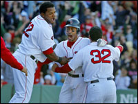  The Red Sox' Julio Lugo (with helmet) is mobbed by teammates Wily Mo Pena (left) relief pitcher (and game winner) J.C. Romero 32, and Alex Cora far right, after his bottom of the ninth inning ground ball was misplayed by the Orioles, and two runs scored, giving Boston an improbable 6-5 comeback victory over Baltimore. (Globe Staff Photo/ Jim Davis)