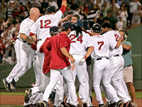   Coco Crisp is at the center of the Red Sox celebration after his game winning double in the 9th inning of the August 14th victory over the Devil Rays.(Barry Chin/Globe Staff)