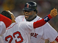   Red Sox DH David Ortiz (right) gets  a hug from teammate Julio Lugo following his home run in the third inning of Game 1 of the ALDS. (Jim Davis/Globe Staff)
