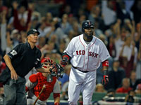   Home plate umpire Gary Darling, Angels catcher Mike Napoli and Red Sox DH David Ortiz all watch the flight of Ortiz's third inning home run during Game 1 of the ALDS, as the crowd goes wild in the background. (Jim Davis/Globe Staff)