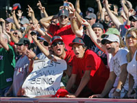   Red Sox fans were all bunched behind the dugout after Boston won Game 3 of the ALDS, cheering the players. (Jim Davis/Globe Staff)