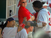   After they hit back to back home runs off of Angels starter Jered Weaver in the fourth inning of Game 3 of the ALDS, Red Sox sluggers Manny Ramirez (left) and David Ortiz (right) compared notes in the dugout. (Jim Davis/Globe Staff)