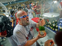   Kevin Youkilis dons protective goggles as he is sprayed with champagne after the Red Sox swept the Angels in the American League Divisional Series. (Jim Davis/Globe Staff)