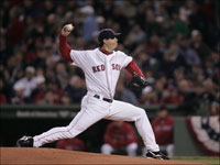   Josh Beckett takes a step towards his postseason legacy as he fires a pitch in the first inning of Game 1 of the ALCS. (Bill Greene/Globe Staff)