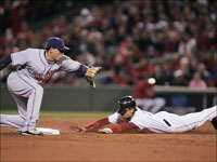   Asdrubal Cabrera reaches for the ball as Red Sox center fielder Coco Crisp steals second base during the third inning of Game 2 of the ALCS.  (Bill Greene/Globe Staff)