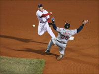   Dustin Pedroia completes the fifth-inning double play as he forces out the Indians Ryan Garko at second base and throws to first to get Jhonny Peralta in the first game of the ALCS. (Stan Grossfeld/Globe Staff)