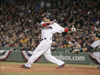   Manny Ramirez singles in the first inning to bring Kevin Youkilis home in the first game of the ALCS.  (Barry Chin/Globe Staff)