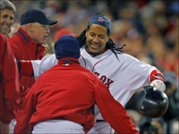   Manny Ramirez gets a lift from Julio Lugo following his record-breaking home run in the fifth inning of Game 2 of the ALCS.  Among the fans cheering is Senator John Kerry. (Jim Davis/Globe Staff)