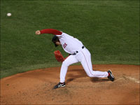   With his familiar no-look delivery to home plate, Hideki Okajima fired a sixth inning pitch against the Colorado Rockies.  (Stan Grossfeld/Globe Staff)