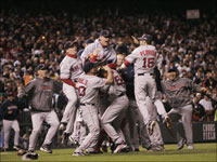   The Boston Red Sox pour onto the field at Coors Field to celebrate their victory in the 2007 World Series. (Barry Chin/Globe Staff)