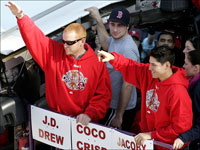   Jacoby Ellsbury and Bobby Kielty wave to the crowd during the Red Sox championship parade. (Barry Chin/Globe Staff)