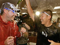   Josh Beckett (left) and Daisuke Matsuzaka celebrated after the game.  (Barry Chin/Globe Staff)