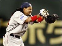 Manny Ramirez grins and points toward the dugout after driving in the winning run against the Oakland Athletics. (Barry Chin/Globe Staff)
