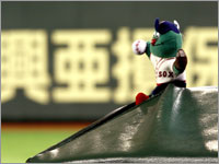 Wally the Green Monster made the trek from Boston to catch the Sox's games in the Tokyo Dome. (Barry Chin/Globe Staff)