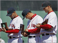 Red Sox relievers Manny Delcarmen, Hideki Okajima and Jonathan Papelbon examine their 2007 World Series rings.