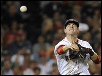 Third baseman Jed Lowrie flips one across the diamond to nail a Baltimore runner.