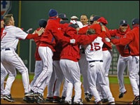 Red Sox players come together around Jed Lowrie after his series-clinching single in Game 4 of the ALDS against the Angels at Fenway.