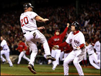 Red Sox first baseman Kevin Youkilis jumps into the arms of teammate Jed Lowrie after scoring the winning run in Game 5 of the ALCS. The Red Sox came back from a 7-0 deficit in the late innings to win Game 5. (Barry Chin/Globe Staff)