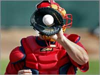 Catcher Kevin Cash performed drills with a tiny catcher's mitt, used to train the backstop's hands behind the plate.  (Jim Davis/Globe Staff)