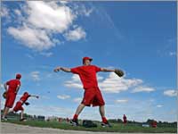 Pitcher Mike Timlin threw under a deep blue sky in advance of the first official workout of Spring Training. (Jim Davis/Globe Staff)