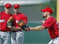 First baseman Kevin Youkilis, reigning American League Gold Glove winner, worked around the bag as Brandon Moss (left) and Chris Carter looked on.  (Jim Davis/Globe Staff)