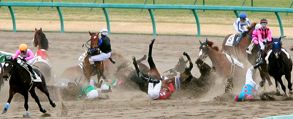 Jockeys fall off their horses during a race at Nakayama racecourse near 