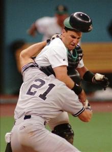 Seattle Mariners catcher John Marzano loses his helmet as he begins a fight with New York Yankees' Paul O'Neill (21) during a baseball game in Seattle in this Aug. 28, 1996 file photo. Police say Marzano was found dead at his home in Philadelphia on Saturday, April 19, 2008. The cause was not immediately clear.